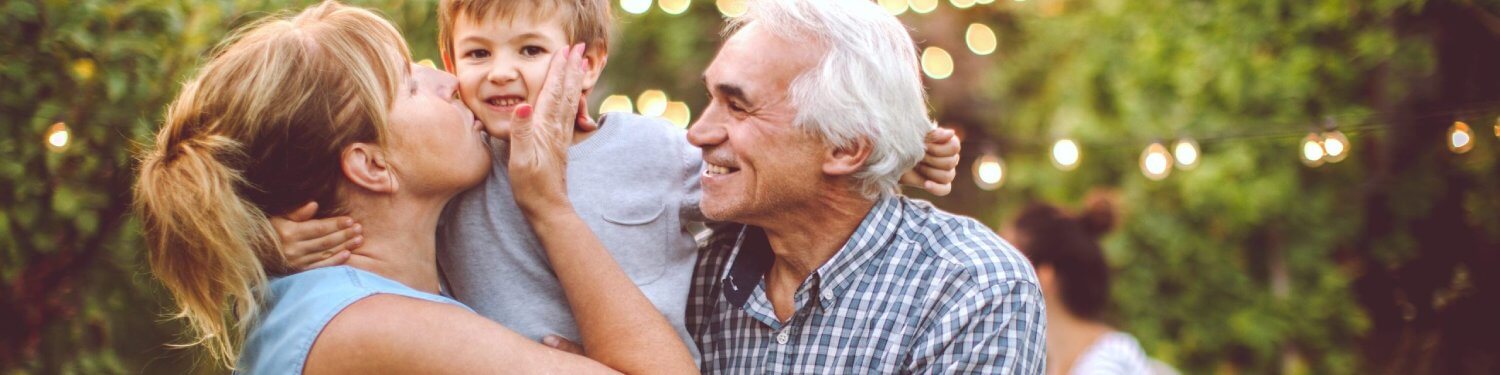 Grandparents holding grandson