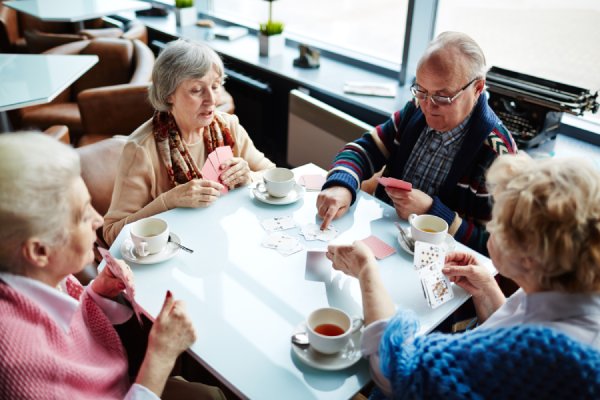 Group of seniors playing cards. 