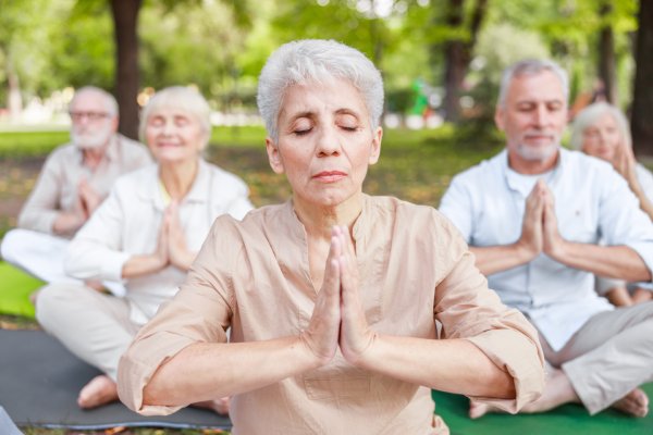 Group of seniors meditating. 