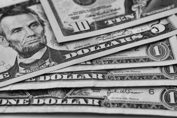 5 dollar bill stacked on one dollar bills to represent financing long term care
